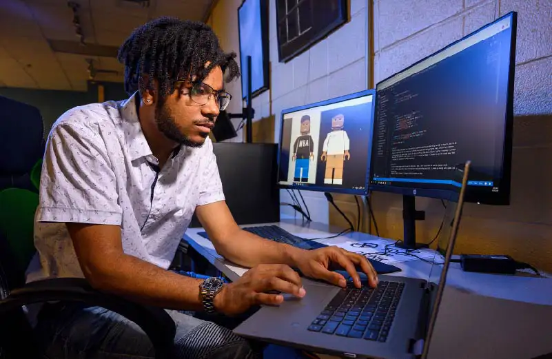 young man typing on a computer