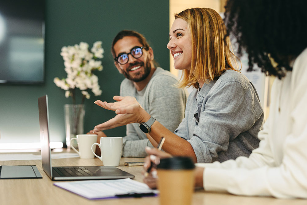 Woman smiling in conversation with others