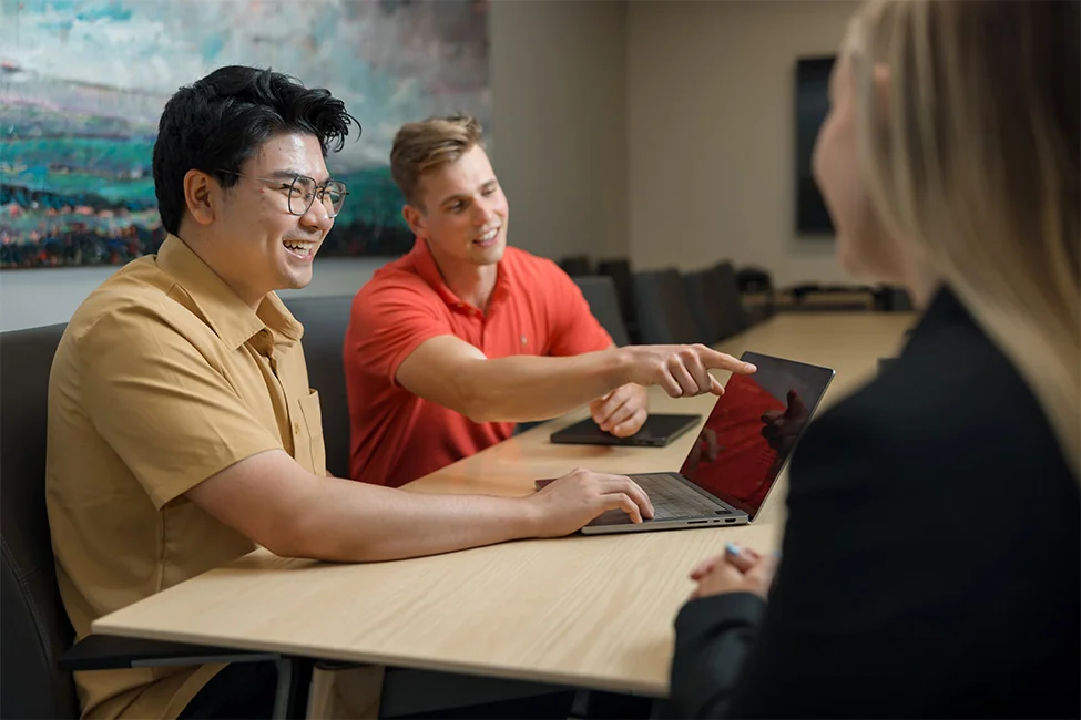 Biola University students working on laptop
