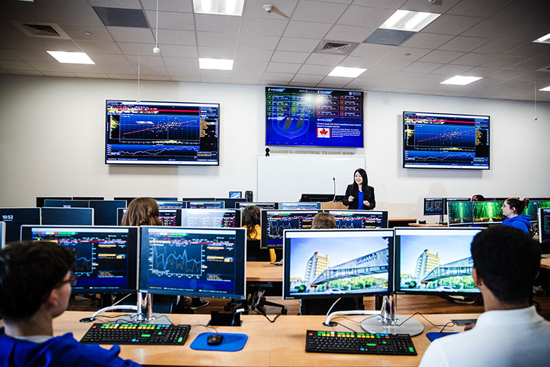 Students in a computer lab listening to a lecture