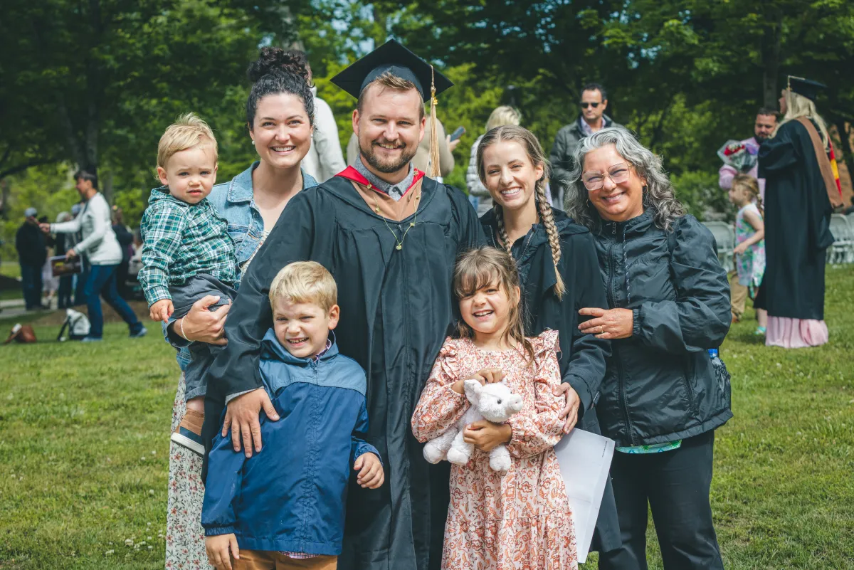 A Bryan College graduate on the lawn with his family after commencement