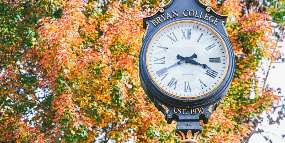 The Bryan College campus clock surrounded by autumn foliage