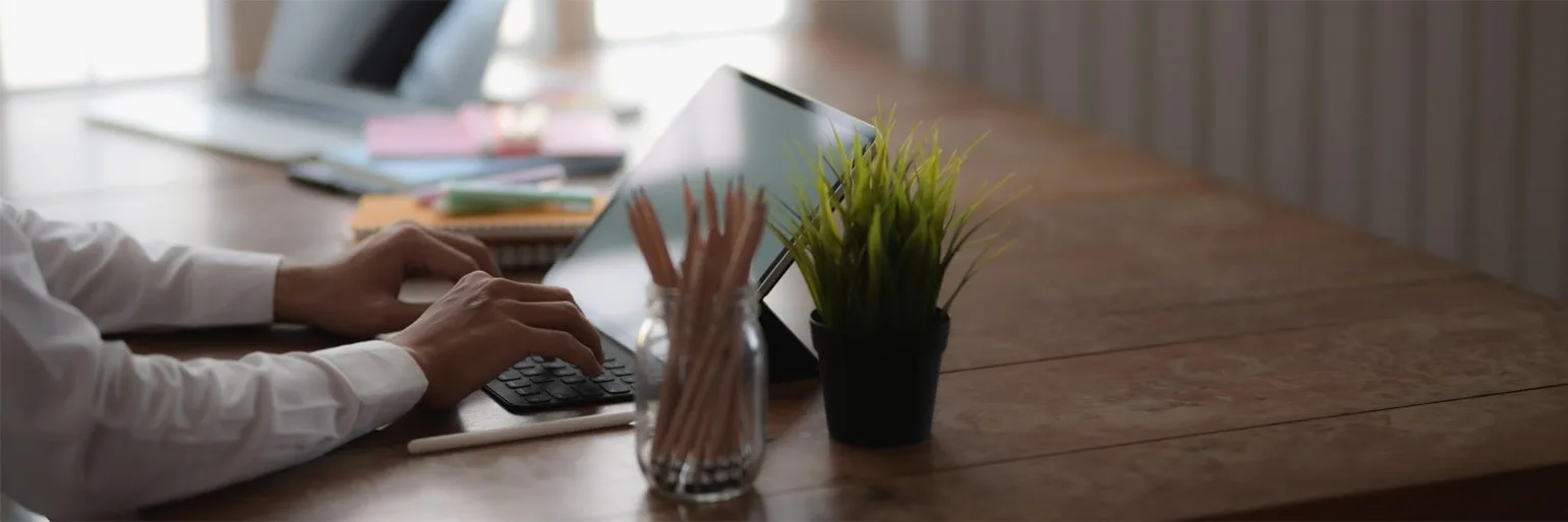 A prospective student typing on a laptop at a desk