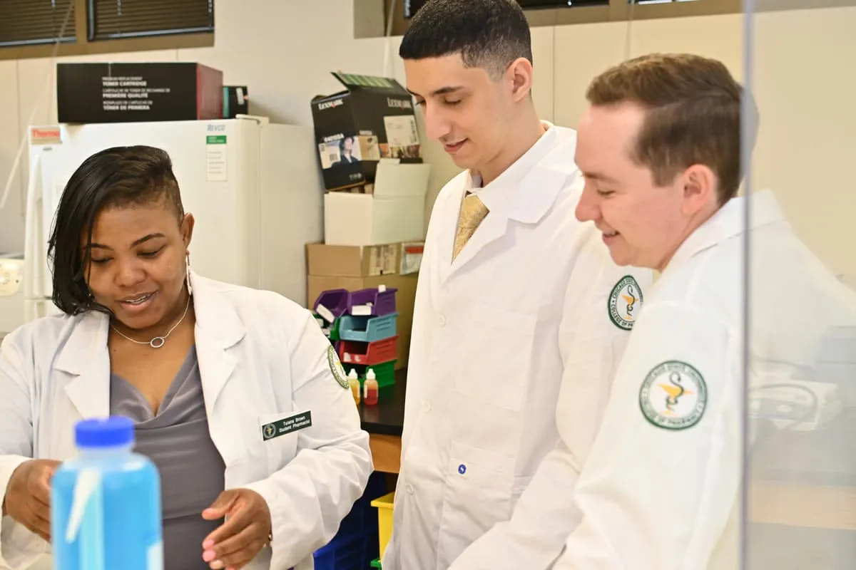 PharmD students working with an instructor in a Chicago State University pharmacy lab.