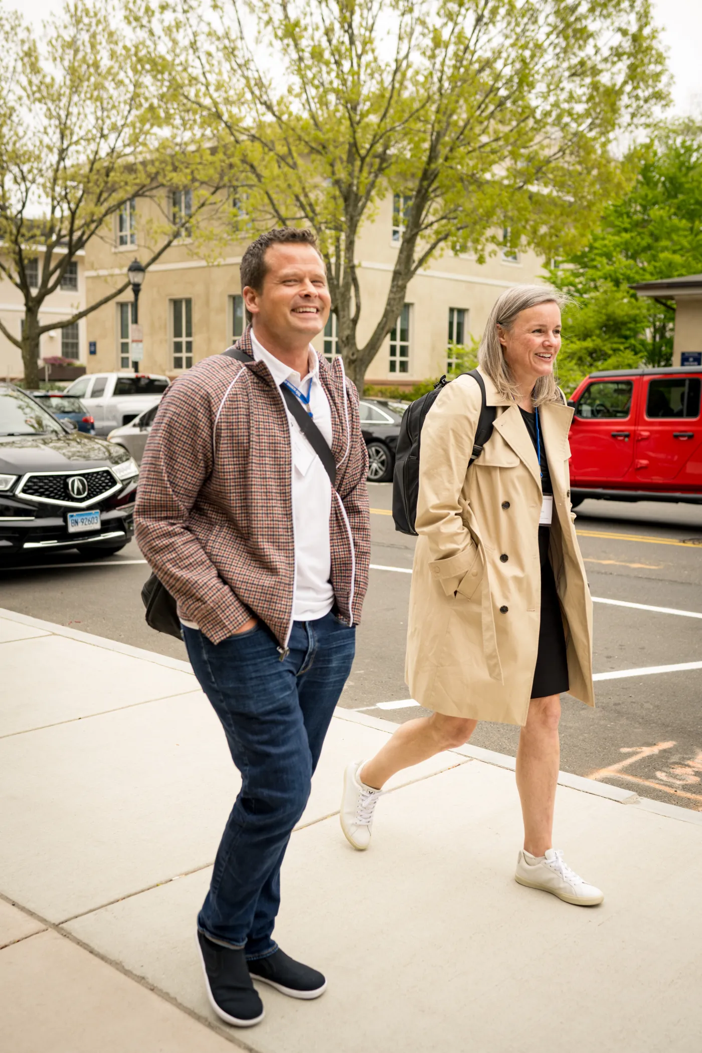 Two smiling people walking together outside